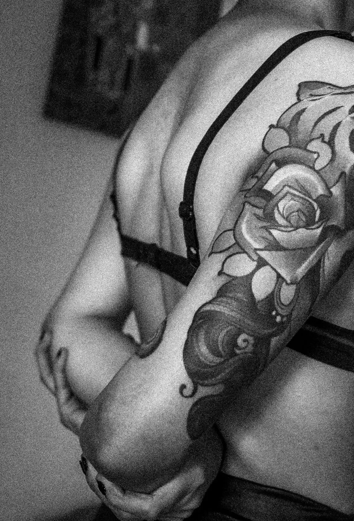 Black-and-grey rose with filigree shaded in soft grey on the shoulder