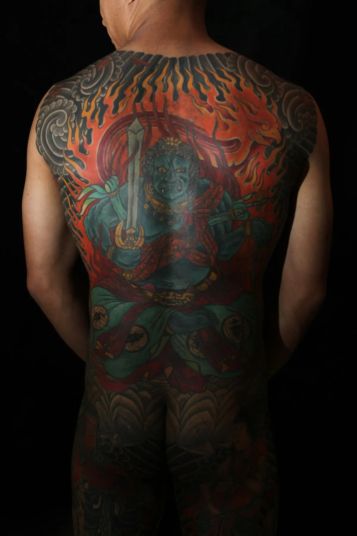 Color irezumi back piece of Fudo Myo-o deity framed by flames and clouds