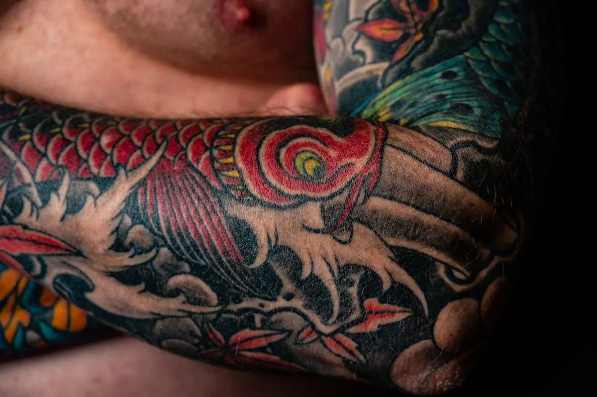 Color koi fish and waves wrapping the elbow on a full sleeve