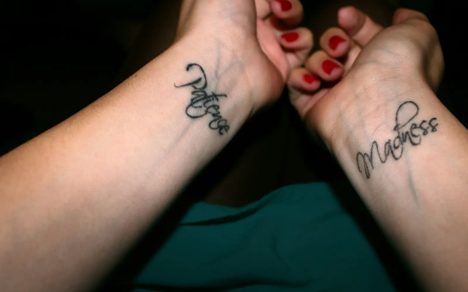 Black script tattoo on wrist