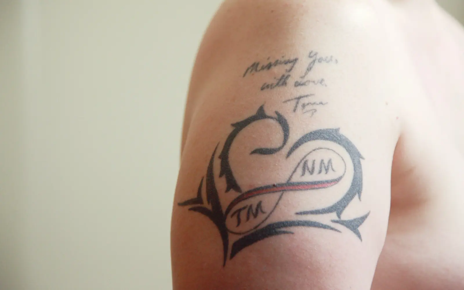 Black and white memorial tattoo on leg