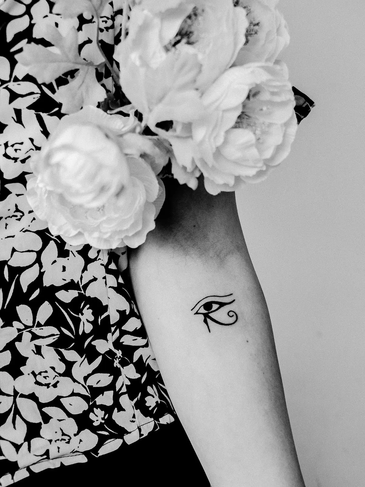 Small fine-line Eye of Horus tattoo on the inner forearm