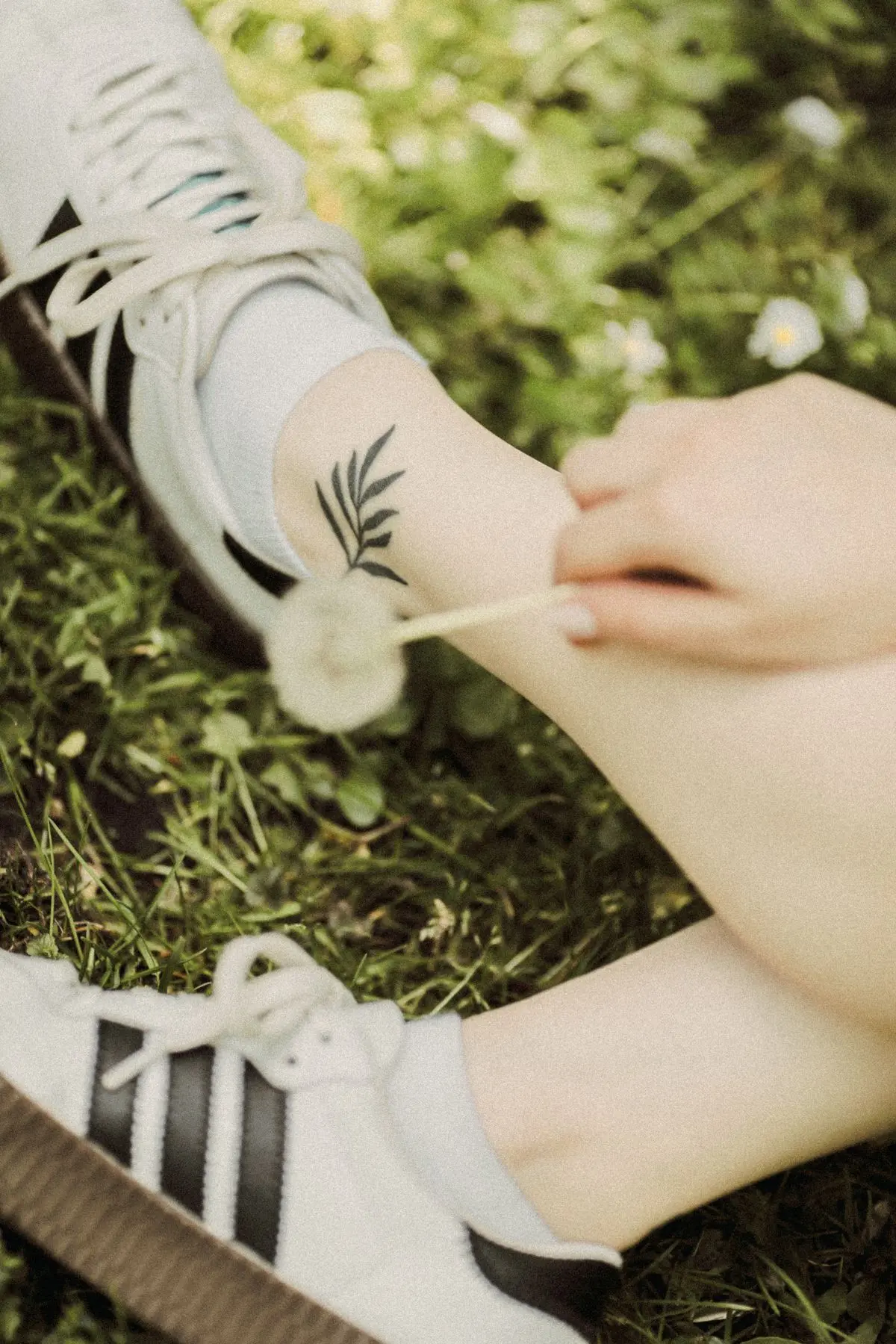 Small minimalist fern leaf tattoo on the ankle