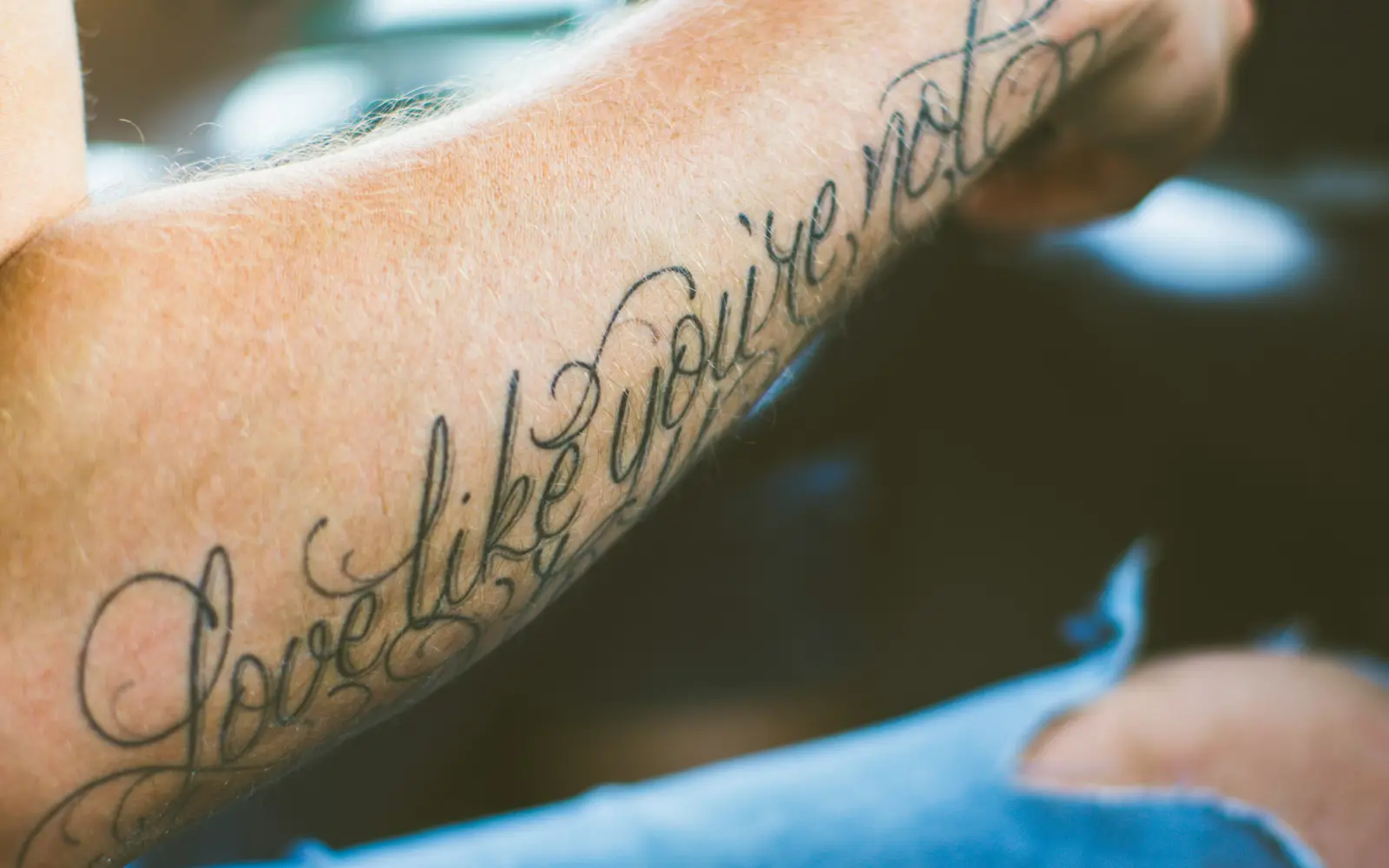 Shallow focus minimalist tattoo on forearm