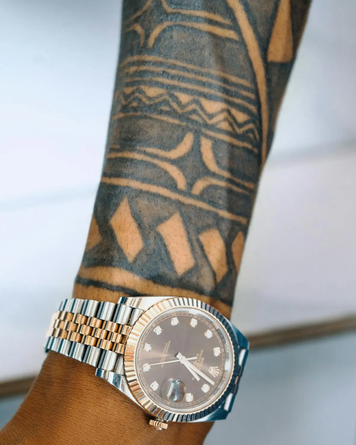 Solid-black Polynesian tribal banding wrapping the forearm
