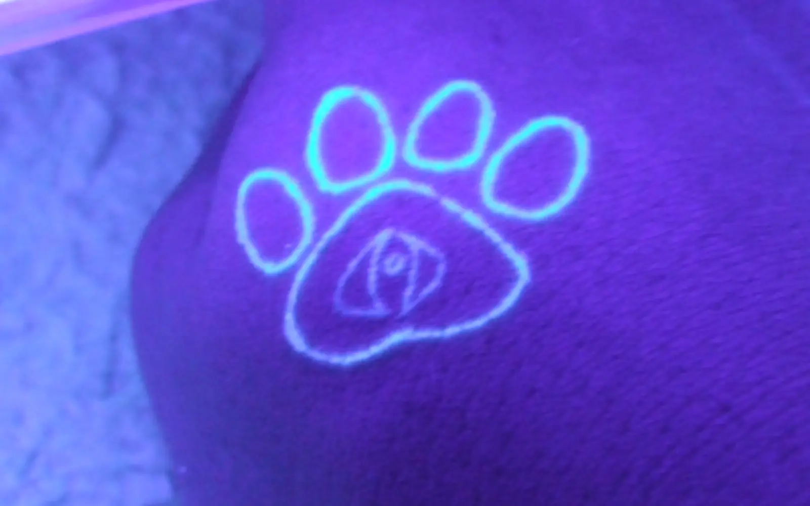 UV tattoo glowing under blacklight illumination